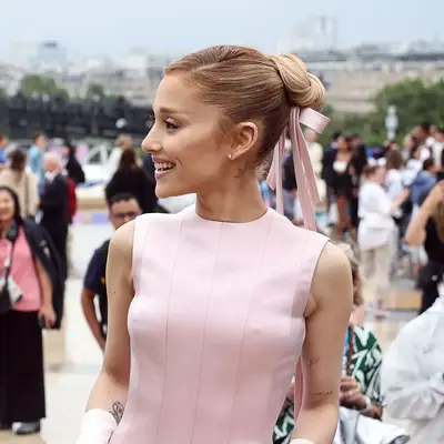 Ariana Grande with bun accessorized with ribbon