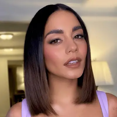 Vanessa Hudgens in a purple top and a rounded bob with center part