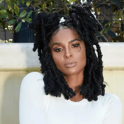 Ciara with a long bob with space buns and dreadlocs