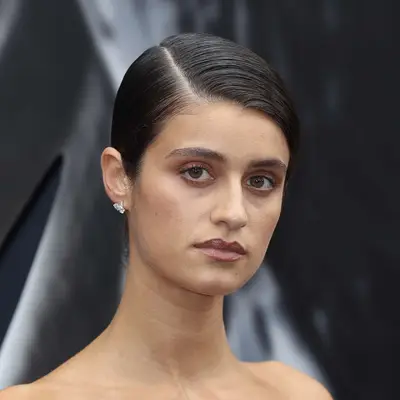 Anya Chalotra with deep side-parted sleek updo