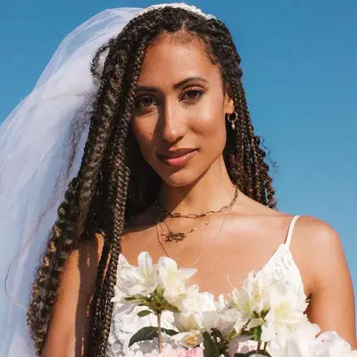 Elaine Welteroth wears a vail and box braids with loose curly ends