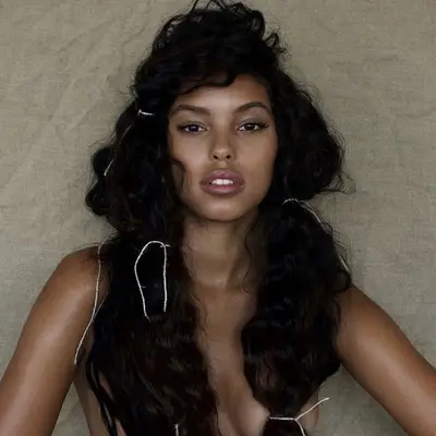 Long, naturally curly hair in loose bubble braids