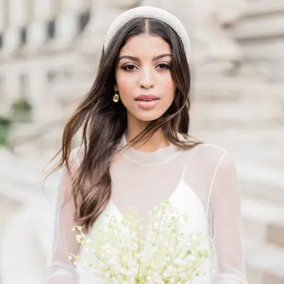 Bride wears loose waves with padded white headband
