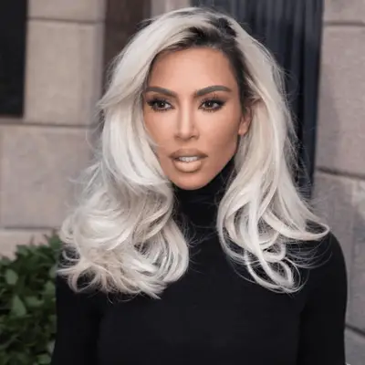 Kim Kardashian with a bleached blonde blowout and lined lips
