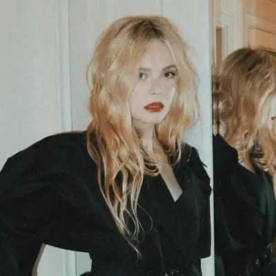 Elle Fanning with long center parted beach waves
