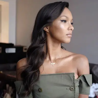 Woman with long, side-swept hair with cascading waves