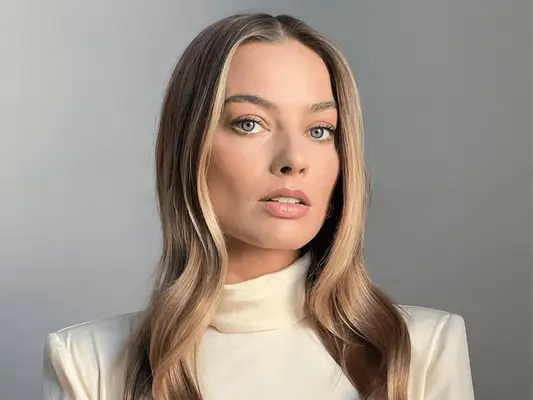 margot robbie with long blonde hair in white dress