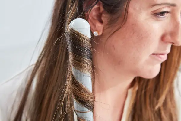 Person curling their hair with the Beachwaver S1-Dual Voltage Rotating Curling Iron