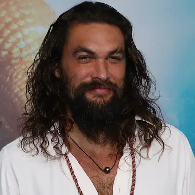 Jason Momoa wears long surfer waves at an Aquaman premiere