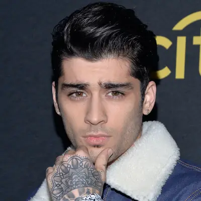 Zayn Malik wears a voluminous greaser pompadour hairstyle