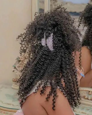 Natural hair pulled back with an oversized clip