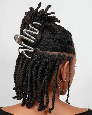 A half up, half down claw clip twist hairstyle