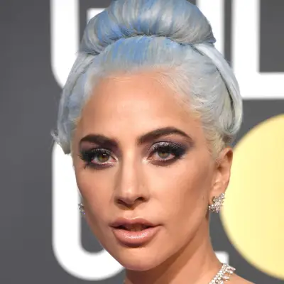 Lady Gaga wears a pastel blue updo and golden radiant skin to the 2019 Golden Globe Awards