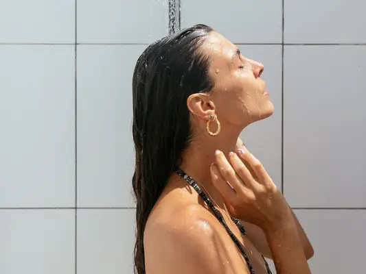 Woman rinsing hair in shower