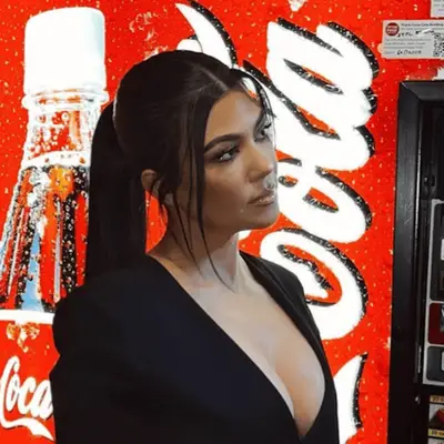 Kourtney Kardashian with a sleek ponytail with face framing tendrils