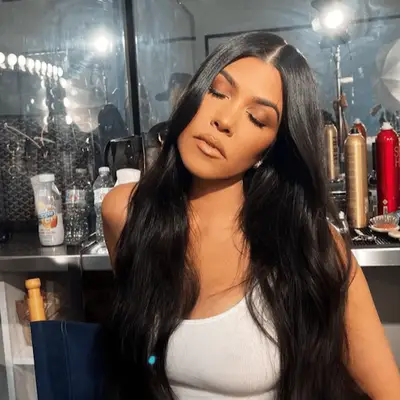 Kourtney Kardashian with center parted loose long hair