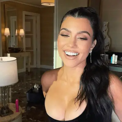 Kourtney Kardashian with a long center parted ponytail