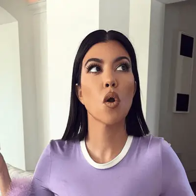 Kourtney Kardashian with a center parted straight bob