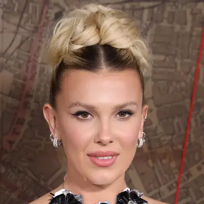 Millie bobbie brown wearing messy blonode updo