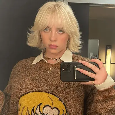 Margot Robbie with a blonde bob haircut styled in an S-wave