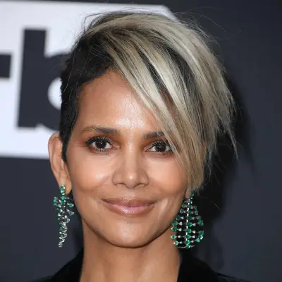 Halle Berry wears a short haircut with dark roots and cool blonde longer ends on top