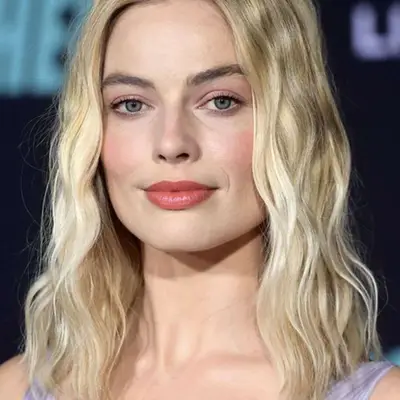 Margot Robbie wears a light blonde long bob hairstyle