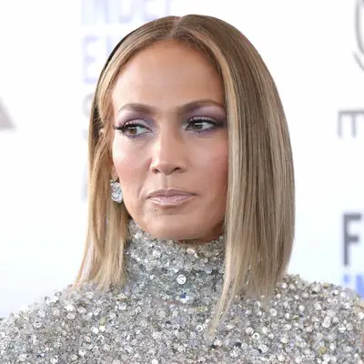 Jennifer Lopez wears dark blonde hair with light golden champagne blonde highlights