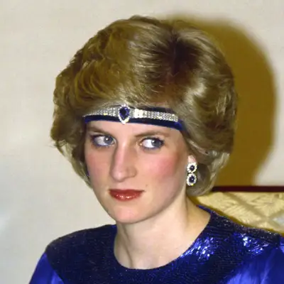 Princess Diana wears a feathered back bob adorned with a bejeweled headband