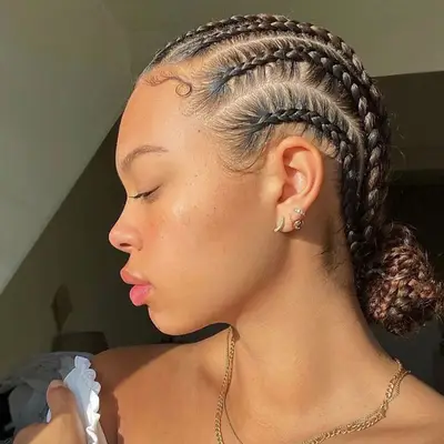 Side profile of woman with cornrow braided low bun