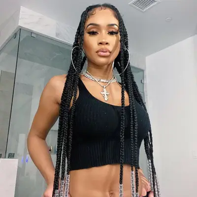 Saweetie wears an ultra-long box braids hairstyle with clear beaded ends