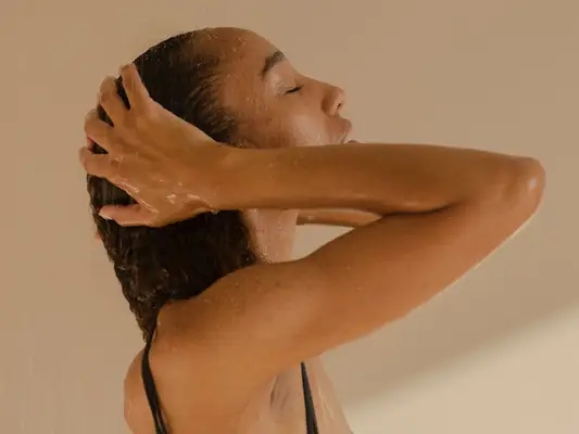woman patting wet hair with hands