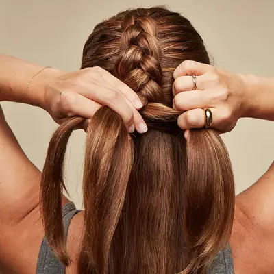 Woman adds hair to her French braid