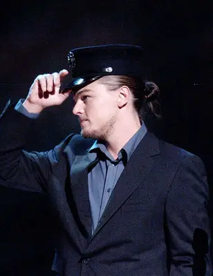 Leonardo DiCaprio with a sleek man bun at 