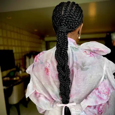 Jumbo cornrows styled in a long braided ponytail