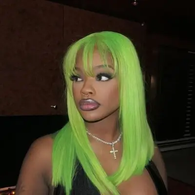 Long shoulder-grazing hairstyle with wispy bangs and lime green color