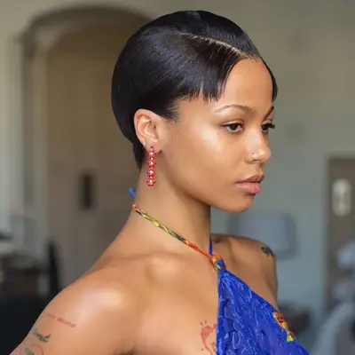 Sleek pixie haircut with side part and slicked bangs