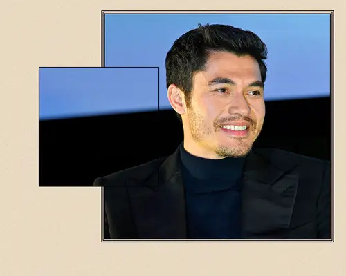Henry Golding with a classic short haircut and black blazer