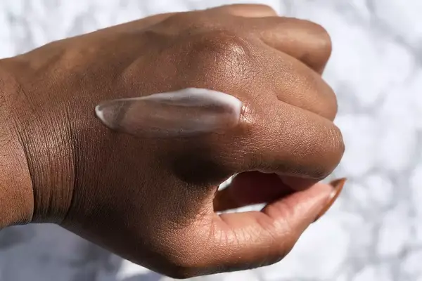 Leave-in conditioner for curly hair smeared on the back of a hand 