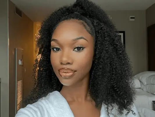 woman wearing her 4b hair in a half-up, half-down style