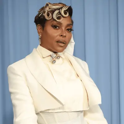 Zoe Saldana posing at an event, smiling at the camera