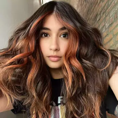 Hayley Williams with half orange and half pink hair