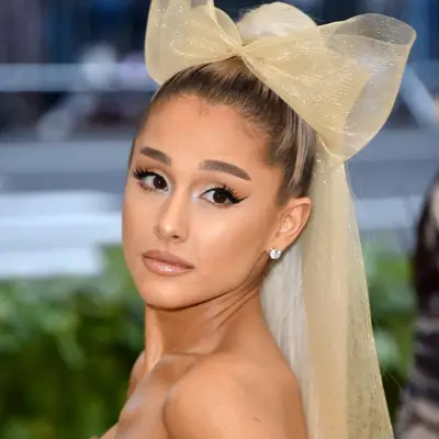 Ariana Grande wears an icy white ponytail extension with her ash brown highlights at the 2018 Met Gala