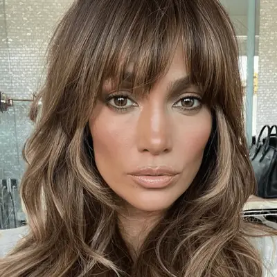 Actor Lily-Rose Depp with ash brown hair in cascading waves