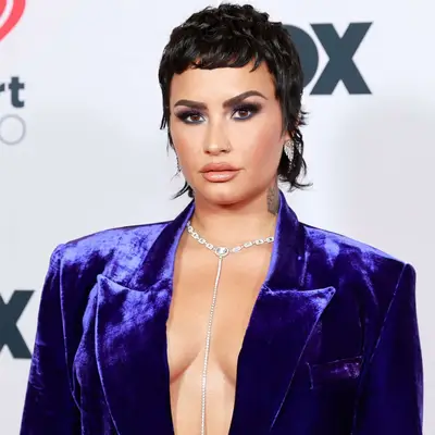 Demi Lovato in blue velvet suit with shullet haircut