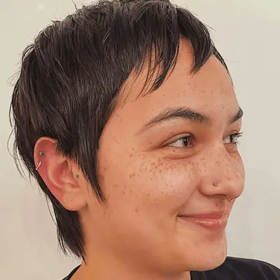 brunnette woman with pixie mullet
