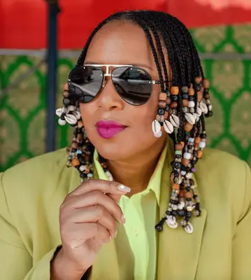 leigh anne pinnock in neon suit with shullet hair