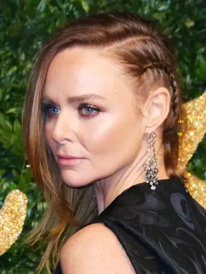 statement earrings hairstyles: Stella McCartney with plaited side part