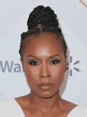 Sydelle Noel wears small and medium cornrows with loc rings and braided bun