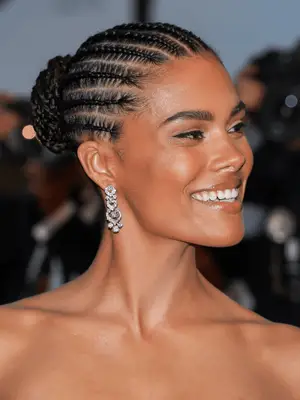 Tina Kunakey in straight-back stitch braids leading to a braided bun