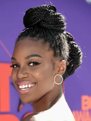 Stacy Ike in half-up half-down box braids with high and low bun